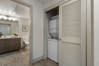 A laundry room with a closet and a toilet and a sink